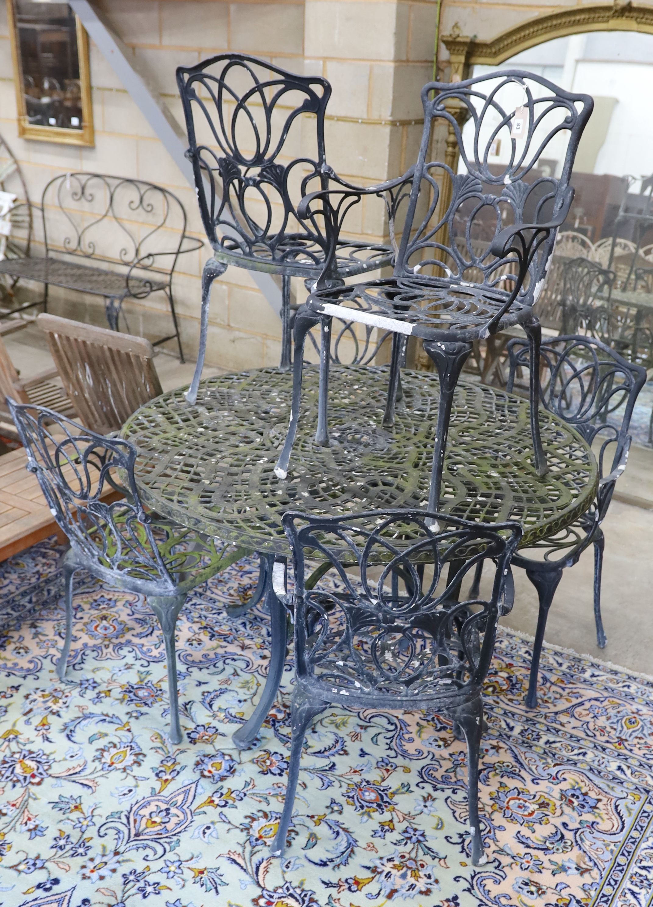 A painted aluminium circular garden table, diameter 124cm, height 73cm and six aluminium garden elbow chairs